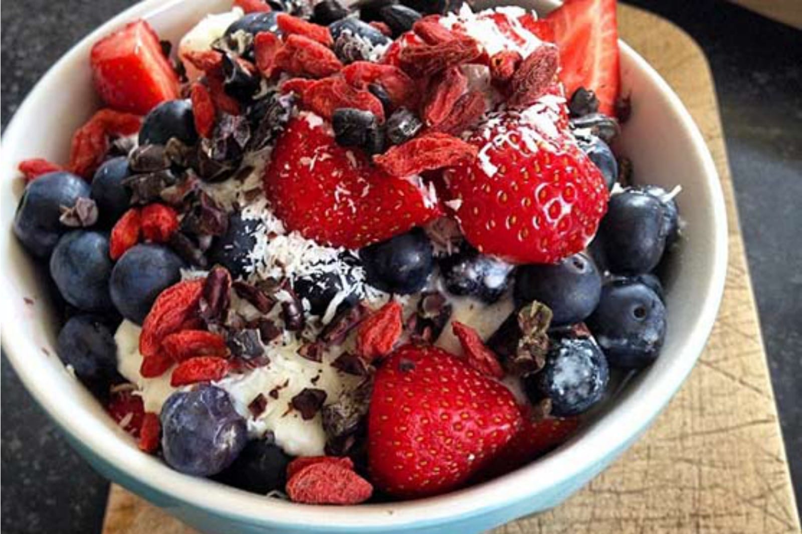 vegan yogurt bowl with fruit. cacao nibs, and coconut