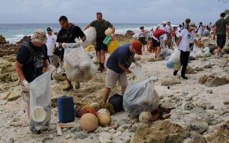 People picking up trash on beach
