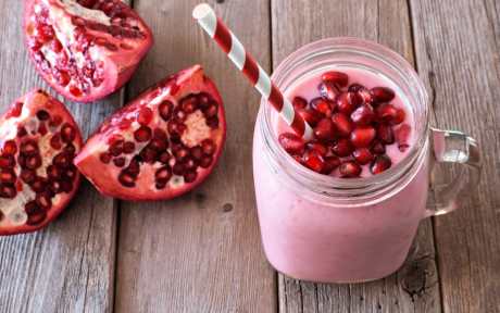 Pomegranate and Pomegranate seeds over pink smoothie