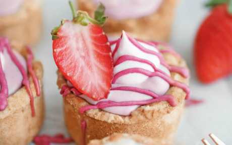 Vegan Gluten-Free Mini strawberry cheesecake tartlets with pink drizzle and fresh berry