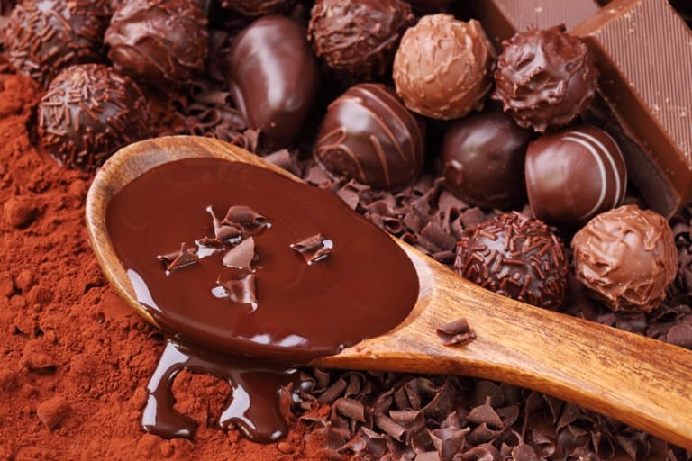 Chocolate sauce on wooden spoon
