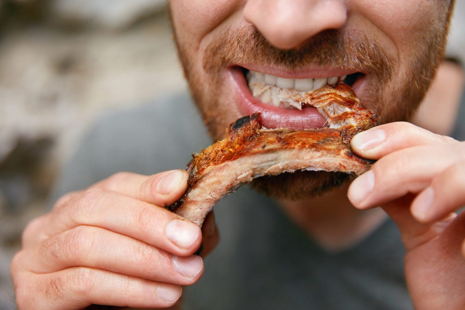 Man eating piece of meat