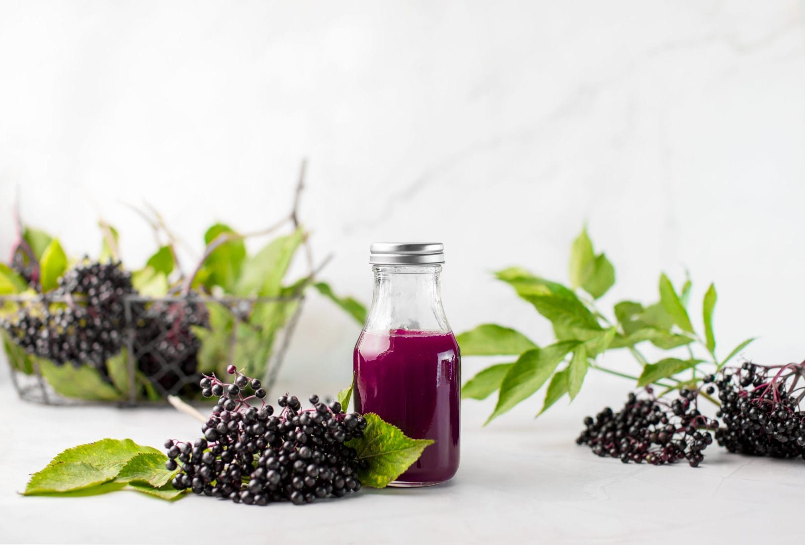 Elderberries with a glass of elderberry juice