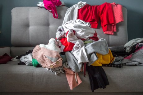 Clothes piled up on couch