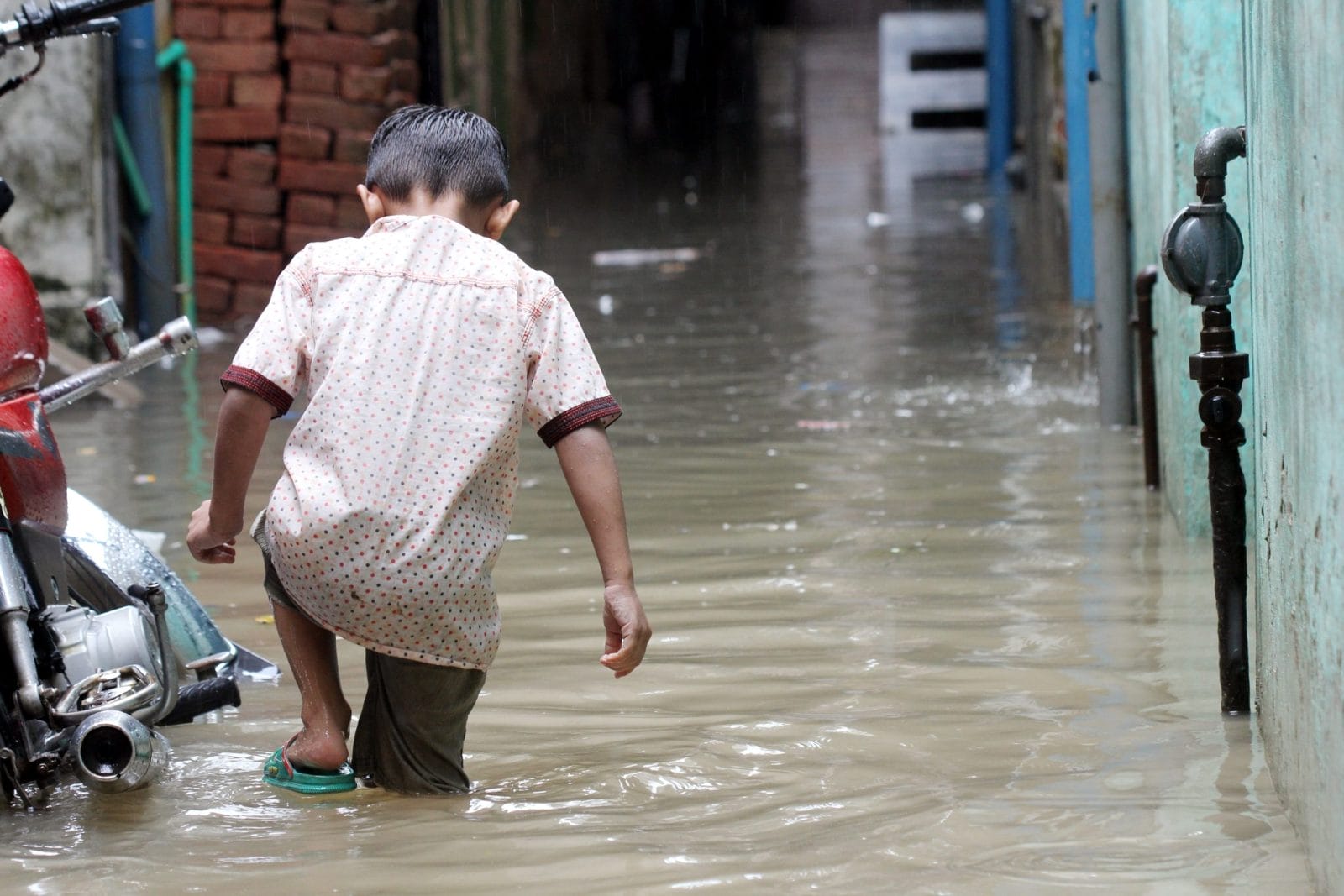 Boy walking in floods in Pakistan